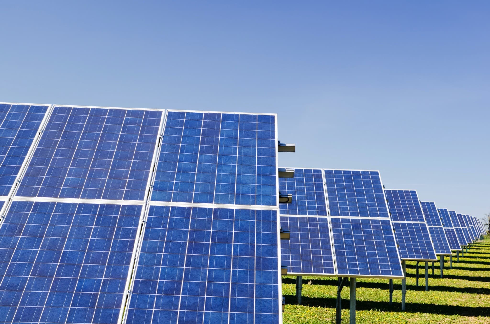 Solar panel array under blue sky